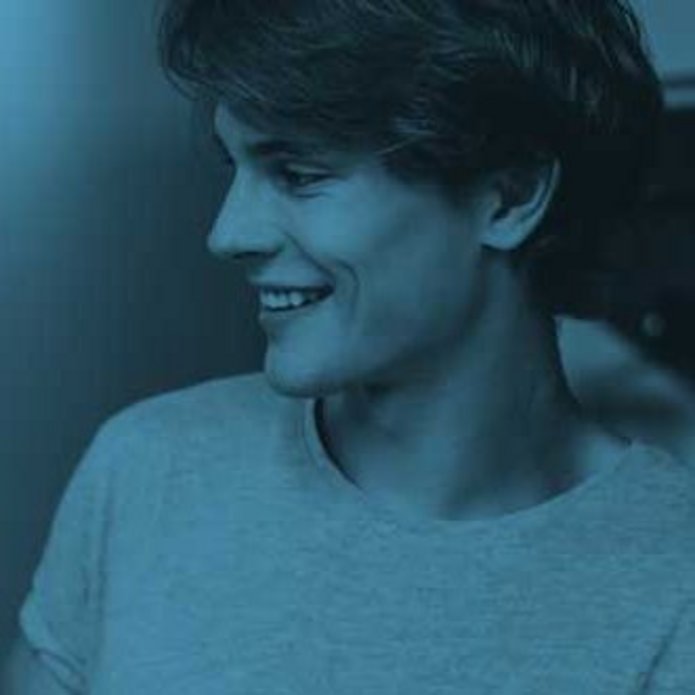 a young man holding a notebook